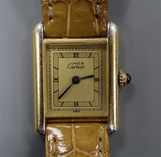 A ladys Must de Cartier 925 Vermeil Tank quartz wrist watch, on Cartier strap, with Cartier box.